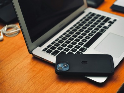 a laptop computer sitting on top of a wooden desk