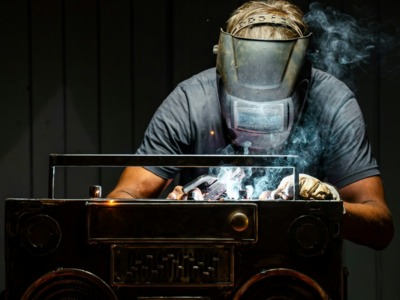 A man in a gas mask working on a radio